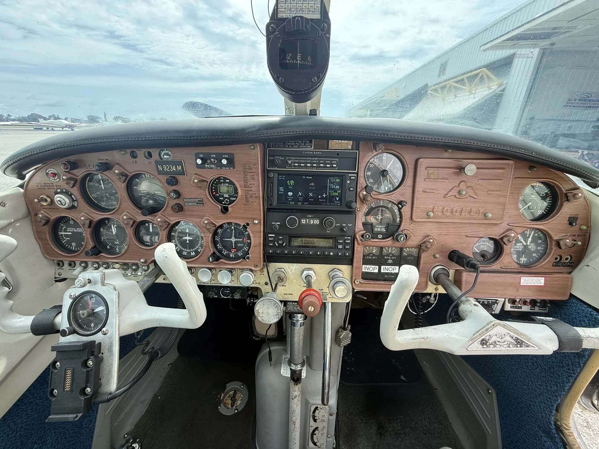 A detailed view of the aircraft's cockpit instrument panel with various gauges, radios, and controls.
