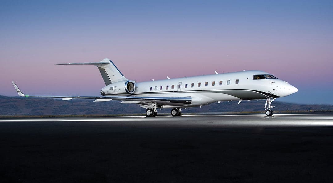 A Bombardier Global Express, registration N40TE, is parked on the tarmac at dusk.