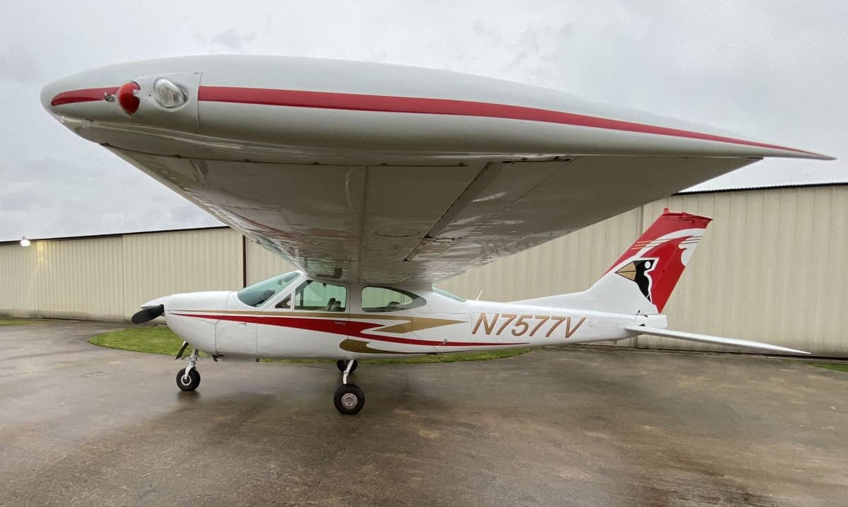 A Cessna 177RG Cardinal, registration N7577V, is parked on the tarmac with a white and red paint scheme.