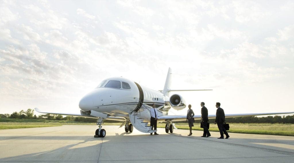 A Citation Latitude jet on the tarmac with people boarding.
