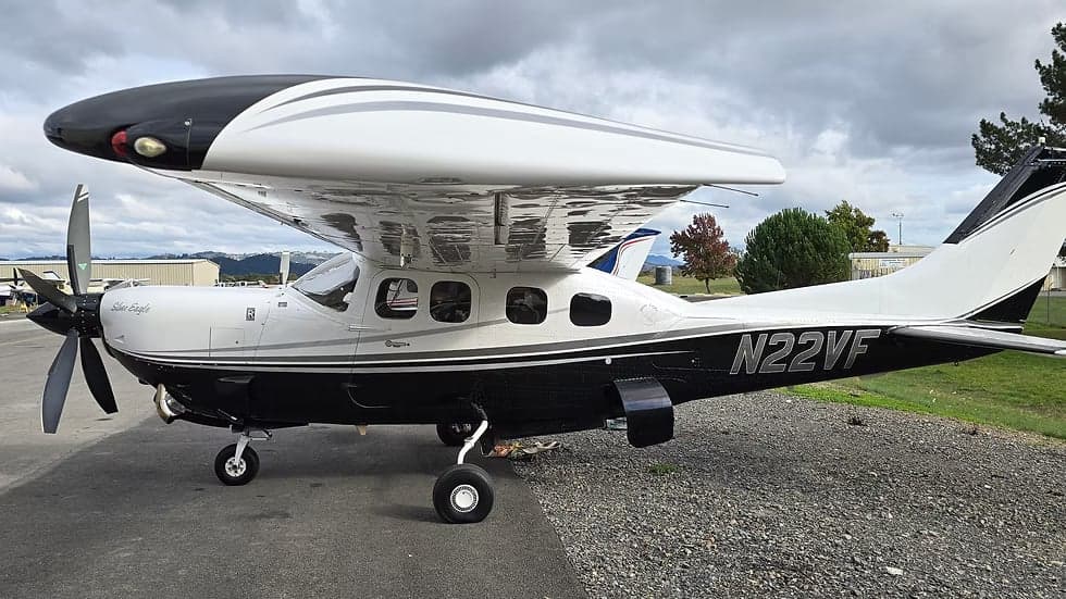 A black and white Cessna 208B Grand Caravan, registration N22VF, is parked on the tarmac.