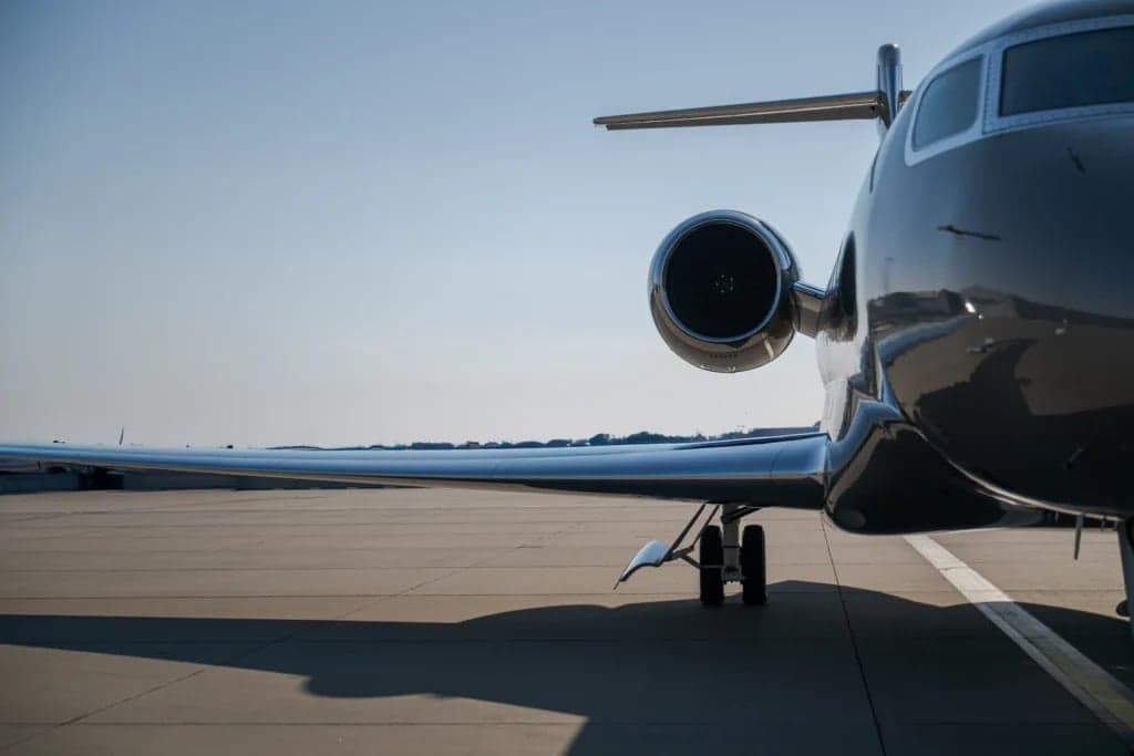 Close-up of the wing and engine of a gray Gulfstream jet.