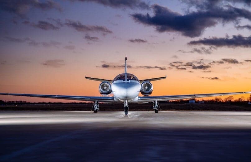Front view of a Cessna Citation CJ3 on the tarmac at sunset.