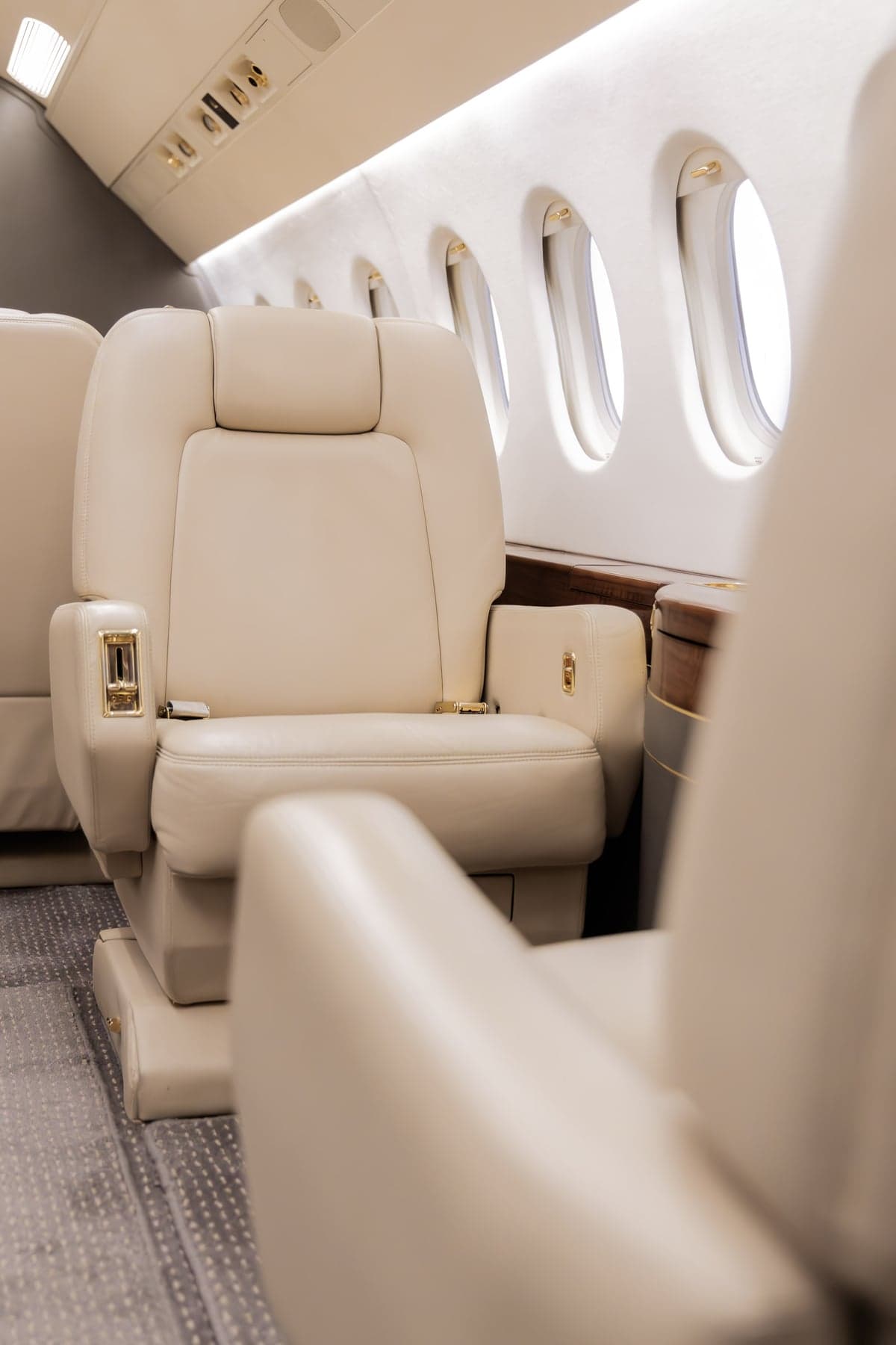 Close-up of a beige leather seat inside the aircraft cabin.