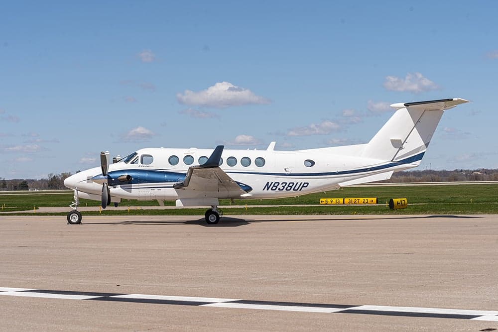 Beechcraft King Air 350i aircraft N838UP parked on the tarmac, side view.