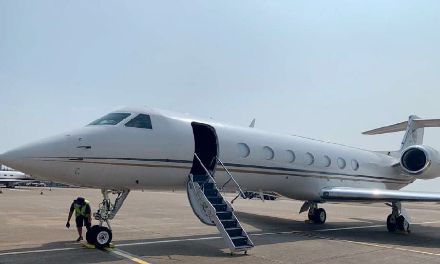 Gulfstream jet on the tarmac with the stairs down.
