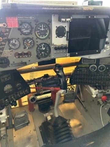 Side view of a yellow and black aircraft with the registration number N9646A in a hangar.