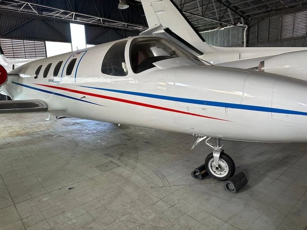 A Cessna Citation CJ1 aircraft is parked in a hangar.