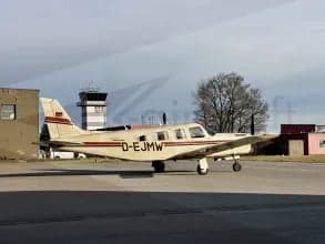A Piper PA-28-181 Archer II, registration D-EJMW, parked on the tarmac.