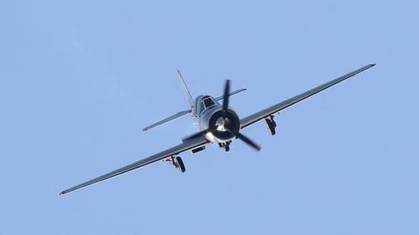 LY-EUG aircraft in flight with a silver and red paint scheme.
