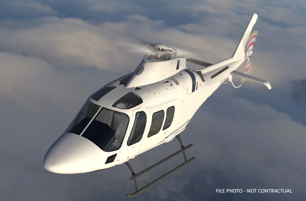 A white Leonardo AW169 helicopter flying above clouds.
