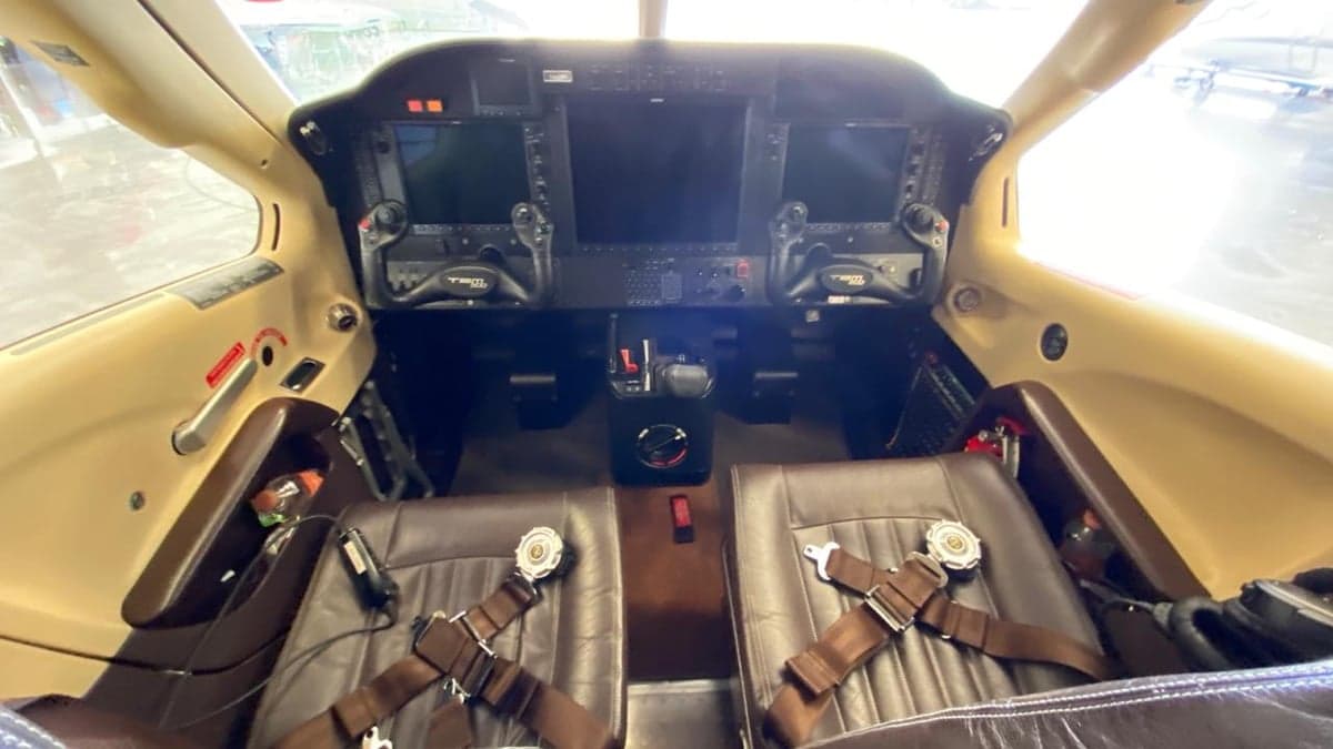 View of the cockpit with leather seats and instrument panel.