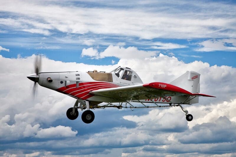 Air Tractor 702 in flight against a cloudy sky.