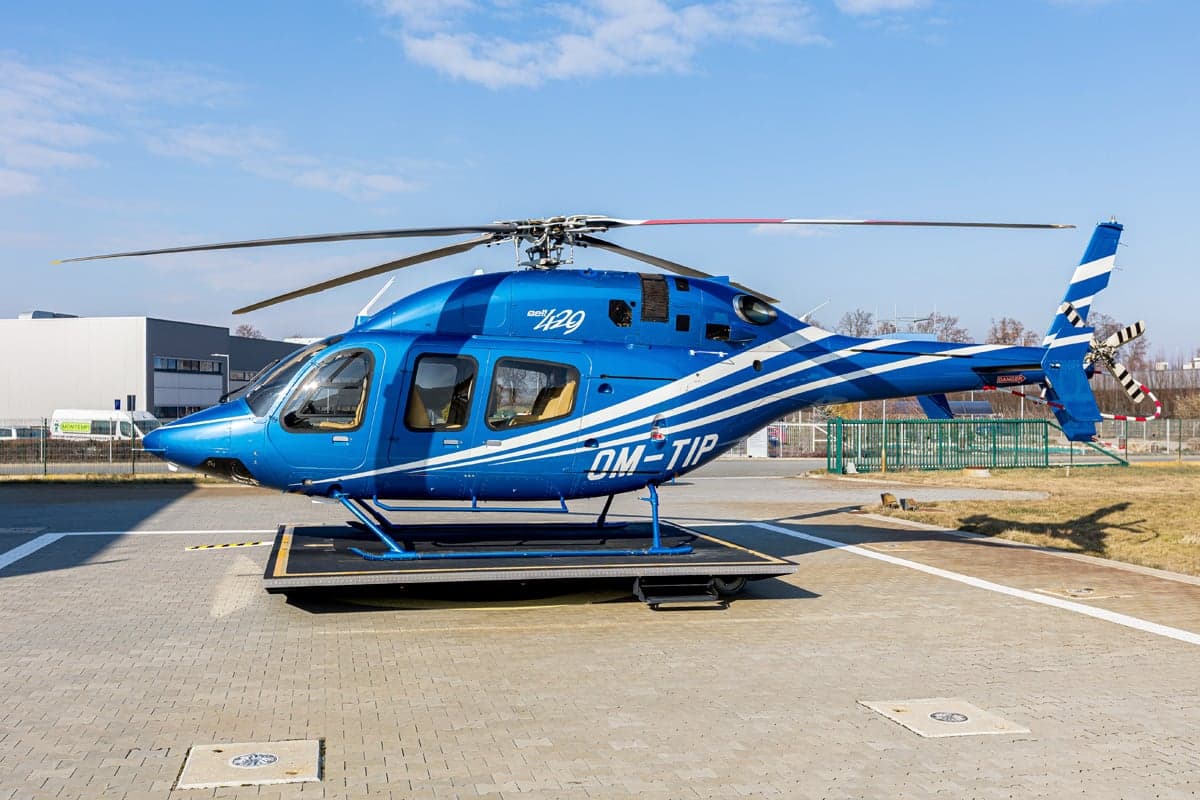 A 2012 Bell 429 helicopter with blue and white paint scheme on a platform.