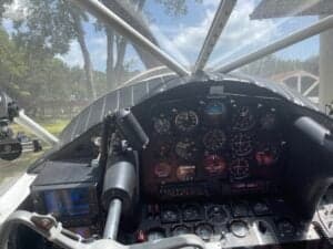 View of the instrument panel and control stick from inside the cockpit of an aircraft.