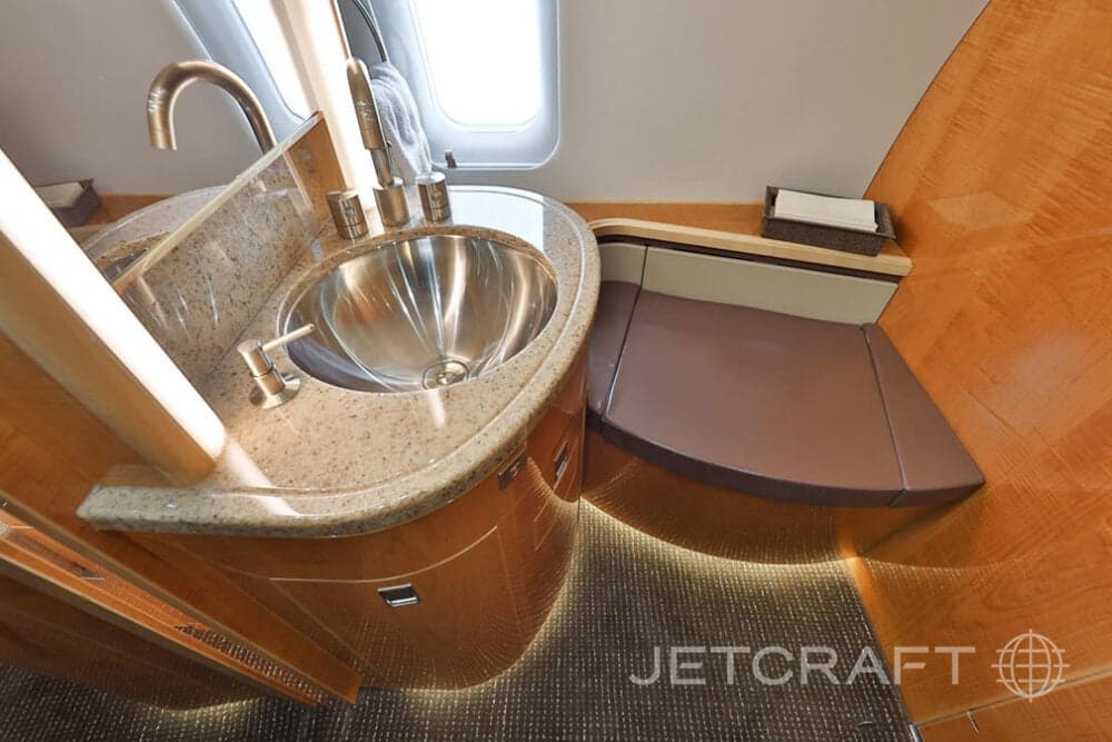 Lavatory area with sink and countertop in the aircraft interior.