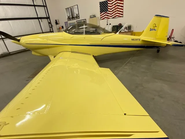 Side view of the yellow N639TB aircraft in a hangar.
