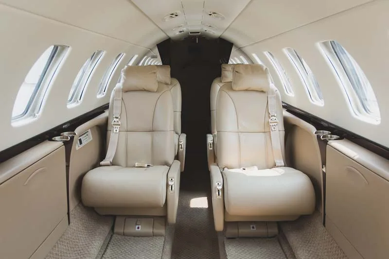 Forward view of the aircraft's interior with leather seats.