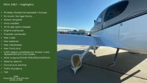 A Cirrus SR22 G3 Turbo aircraft with a white and gray paint scheme, side view.