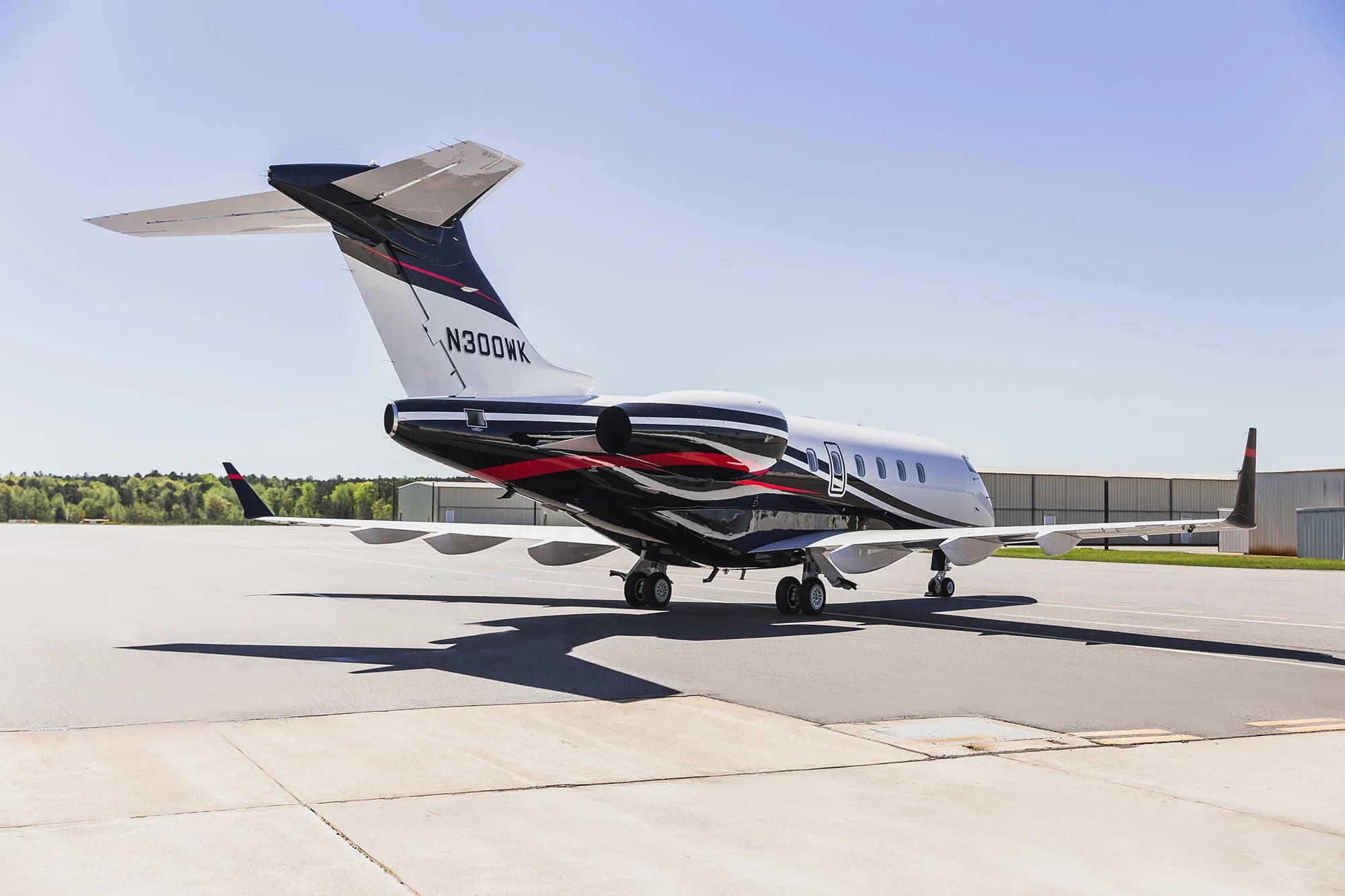 Rear quarter view of the N300WK aircraft on the ground.