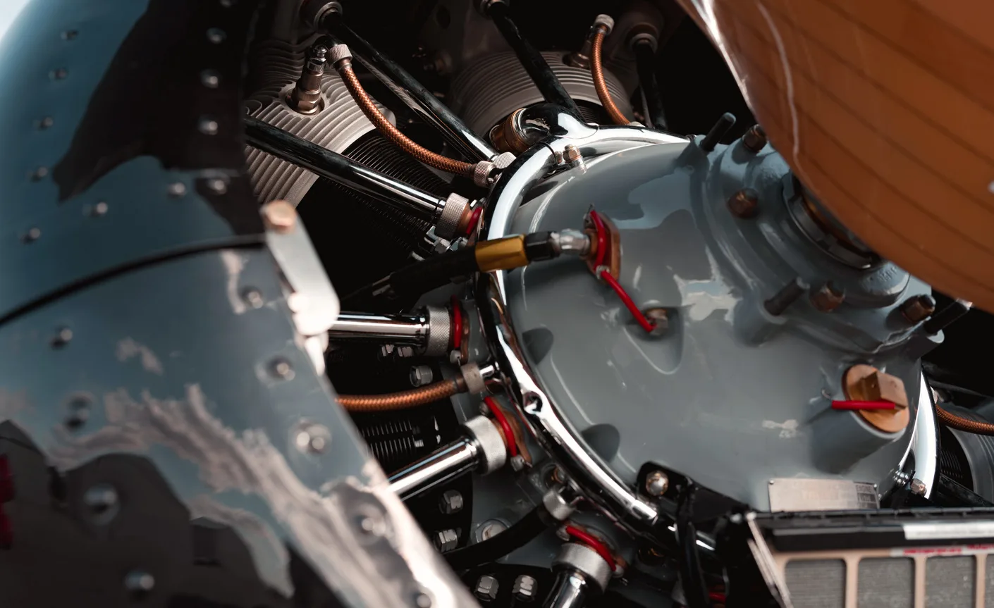 Close-up of the engine of a black and red biplane.