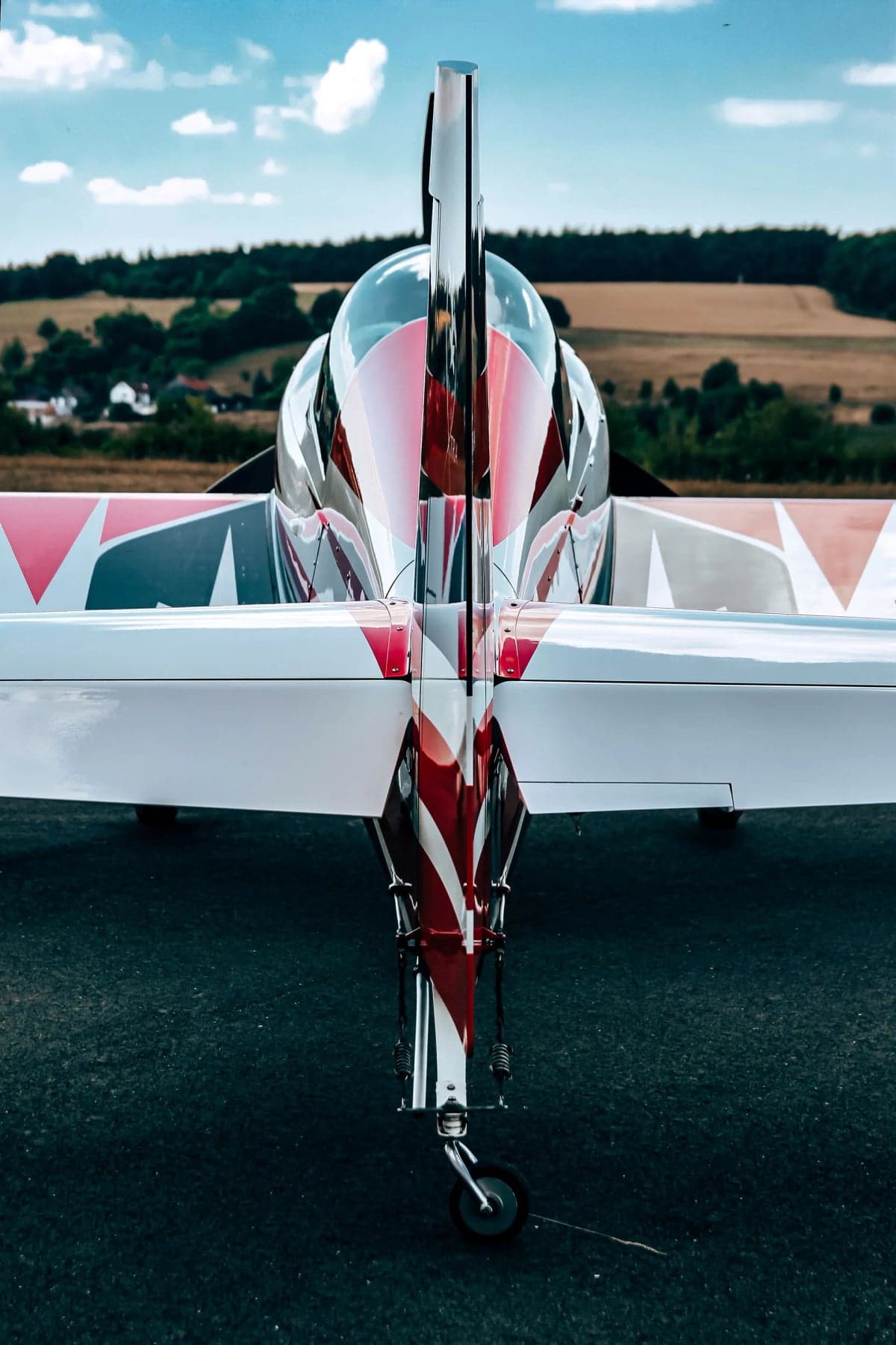 Close up of the tail of a red and white Extra EA-300LX.