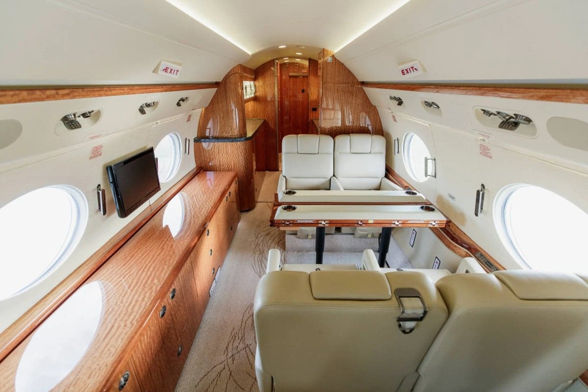 A view of the Gulfstream G550 cabin showing the seating arrangement and interior design.