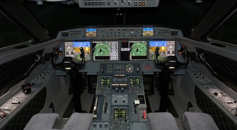 A view of the aircraft's interior with two seats and tables.