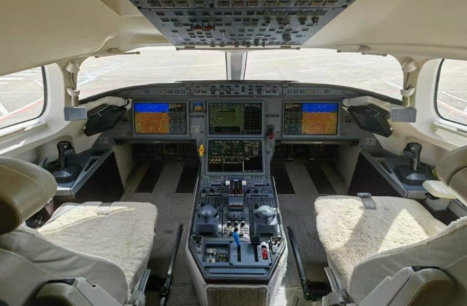 View of the aircraft cockpit with instrument panel and seats.