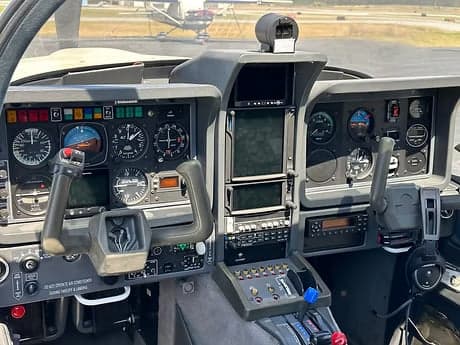 The instrument panel and controls of an aircraft cockpit.