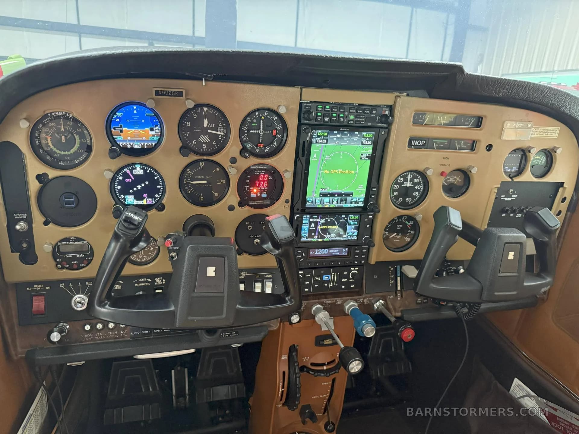 A detailed view of an aircraft cockpit featuring a mix of analog gauges and modern digital displays.