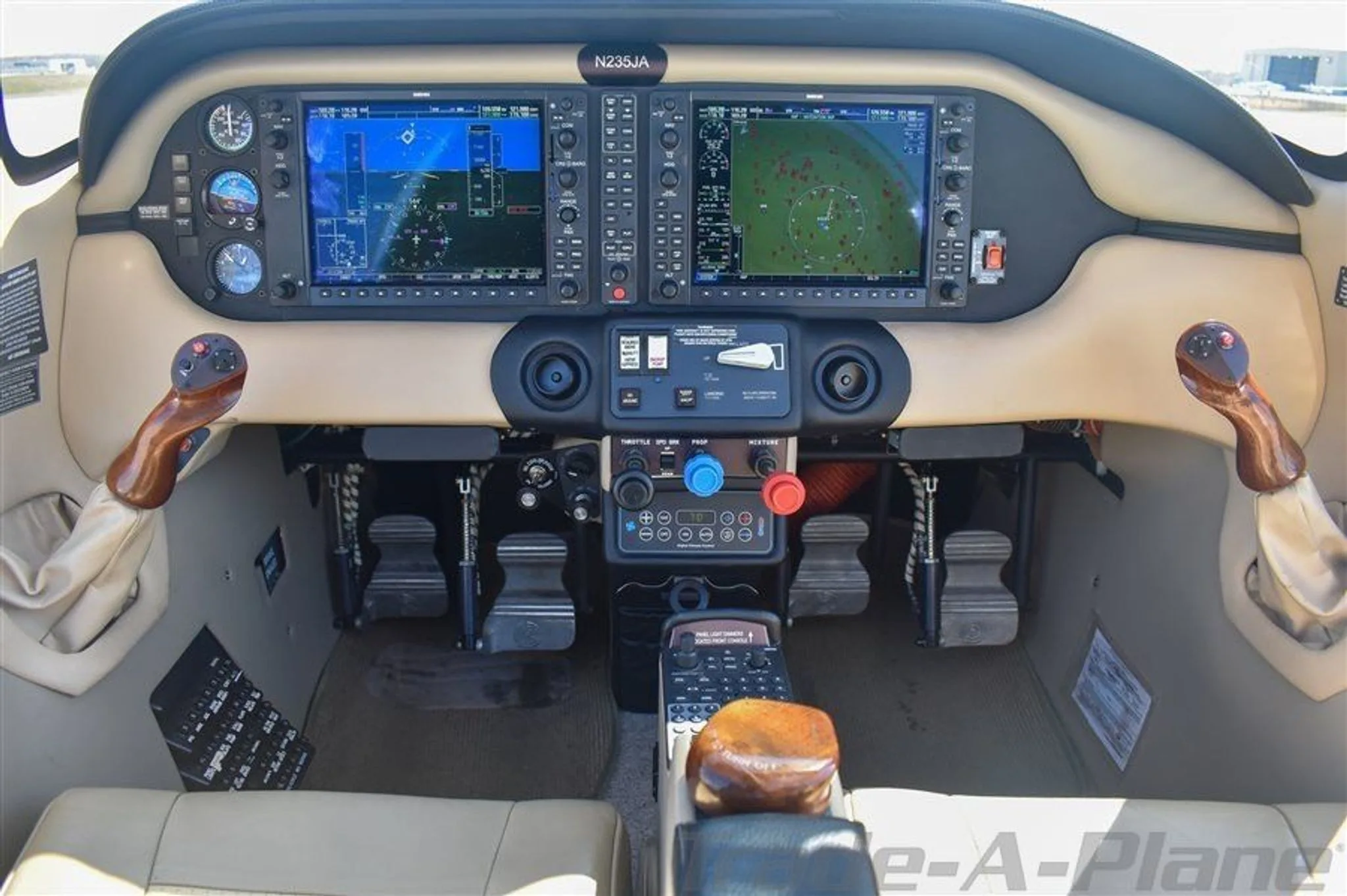 The cockpit of the Cessna 400 N235JA features a glass panel display with two large screens and dual yokes.