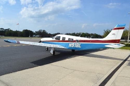 A Piper PA-28-181 Archer II aircraft with registration N918L is parked on the tarmac.