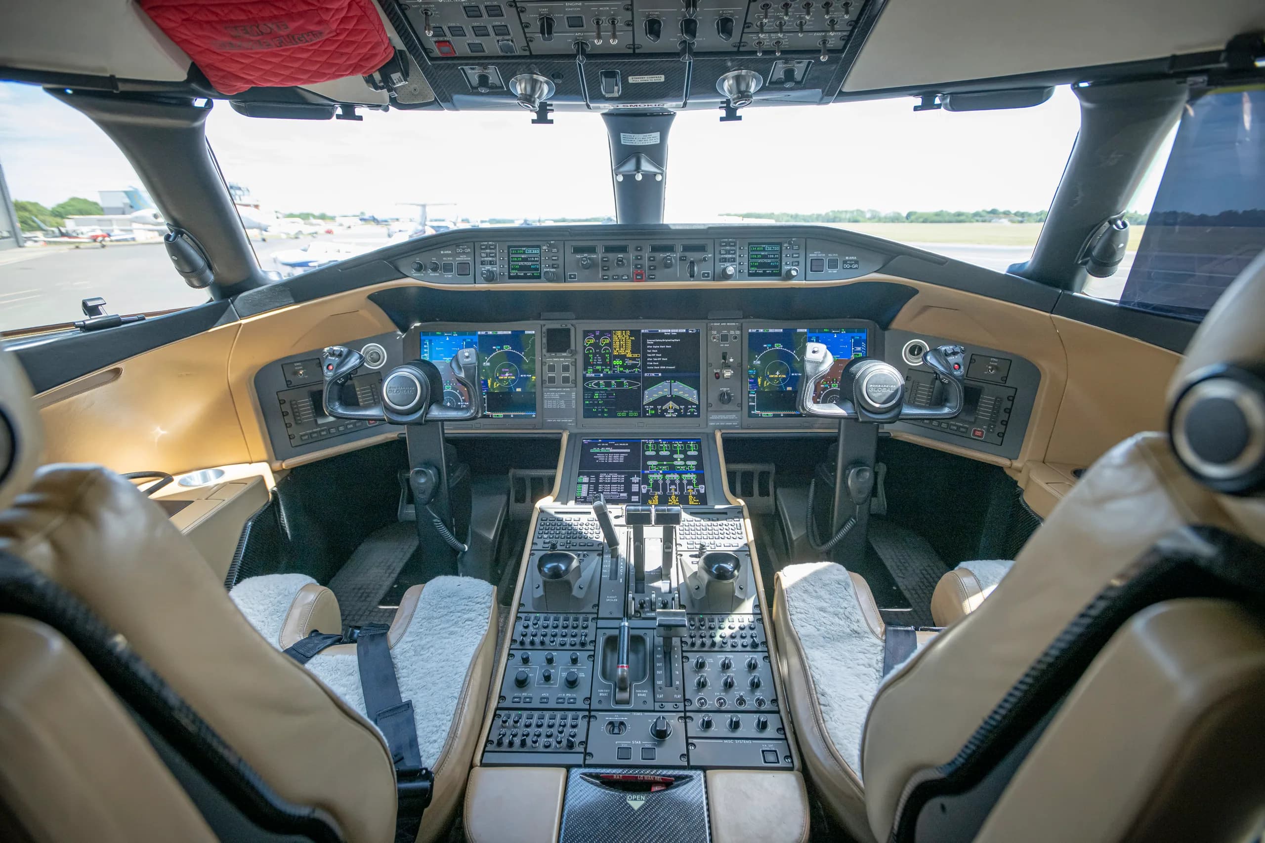 A view of the aircraft's cockpit with tan leather seats.