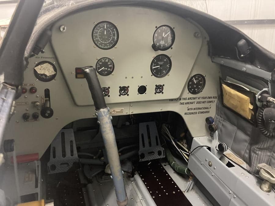 View of the instrument panel and controls inside the cockpit of an aircraft.