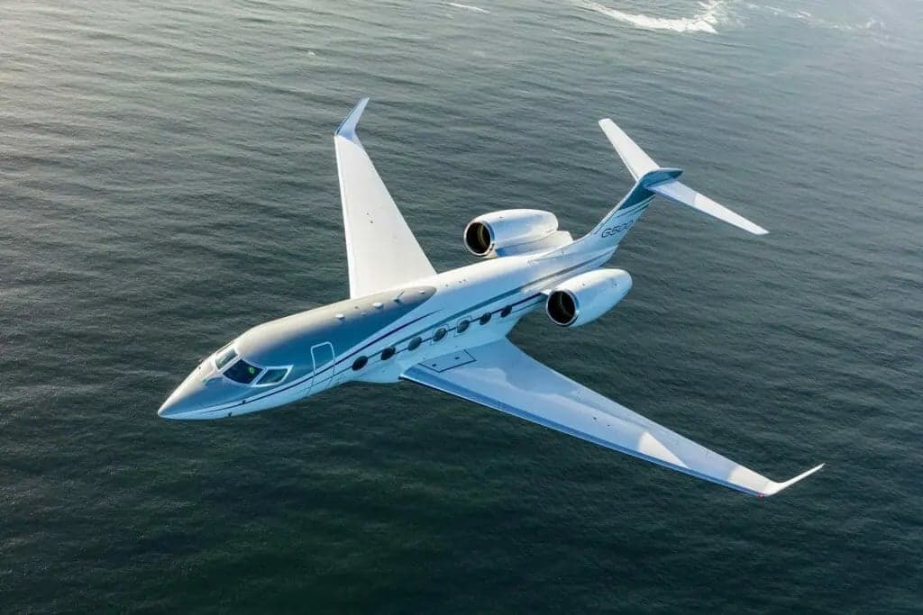 Aerial view of a Gulfstream G650 over the ocean.