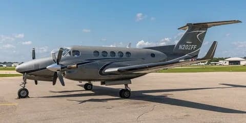 Side view of a gray King Air aircraft on the tarmac.