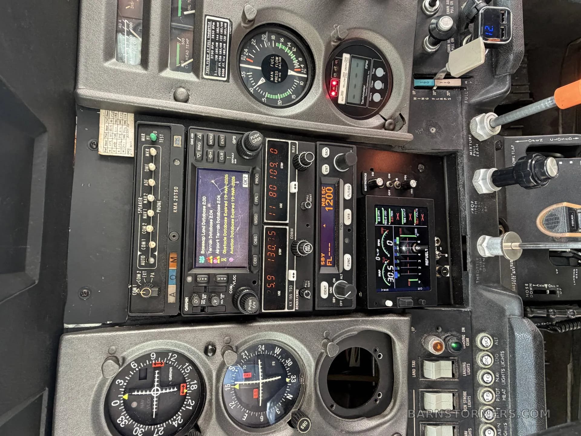 A detailed view of an aircraft's avionics stack, including radios, GPS, and other navigation instruments.