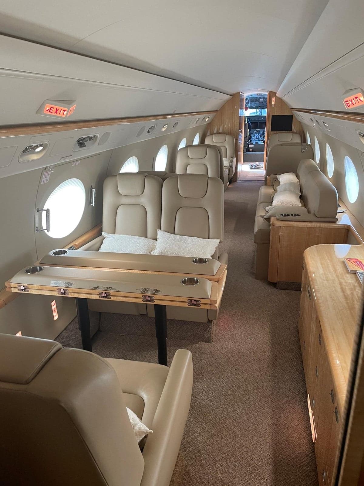 A view of the interior of the aircraft, showing seating and tables.