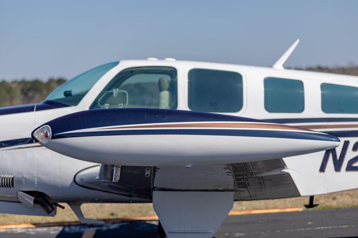 Close up of the wing and side windows of the Beechcraft Bonanza N219DK.