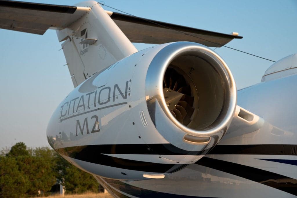 Close-up of the engine and tail of a Citation M2 aircraft.