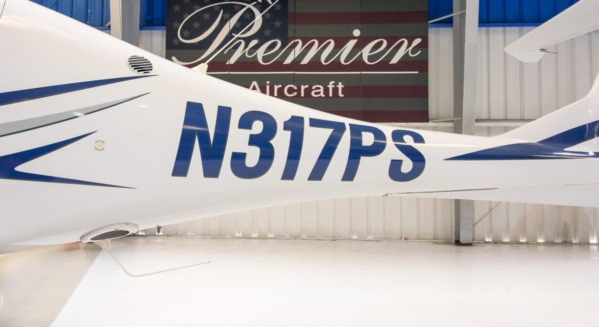 Close up of the tail of a Diamond DA40 aircraft with registration N317PS.