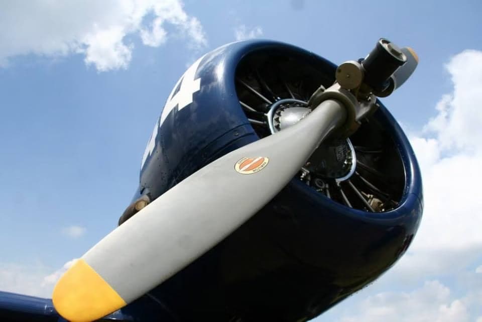 Close-up of the engine and propeller of a blue North American T-6 Texan aircraft.