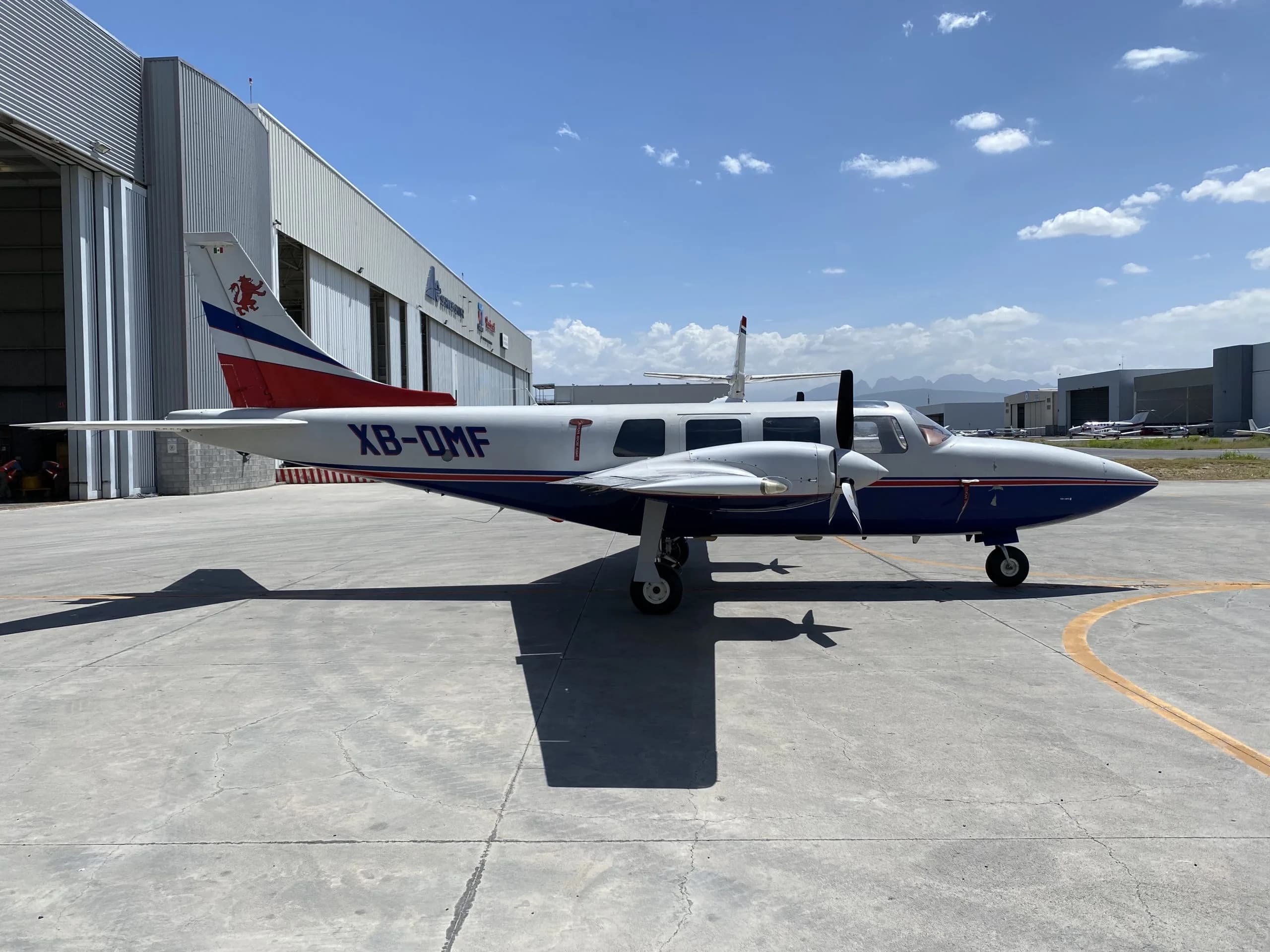 Side view of the XB-DMF aircraft parked on the tarmac.