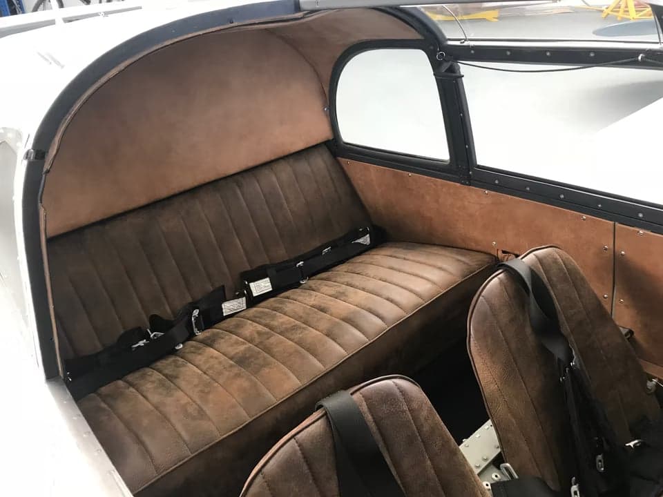 Interior view of the aircraft cabin with brown seats.