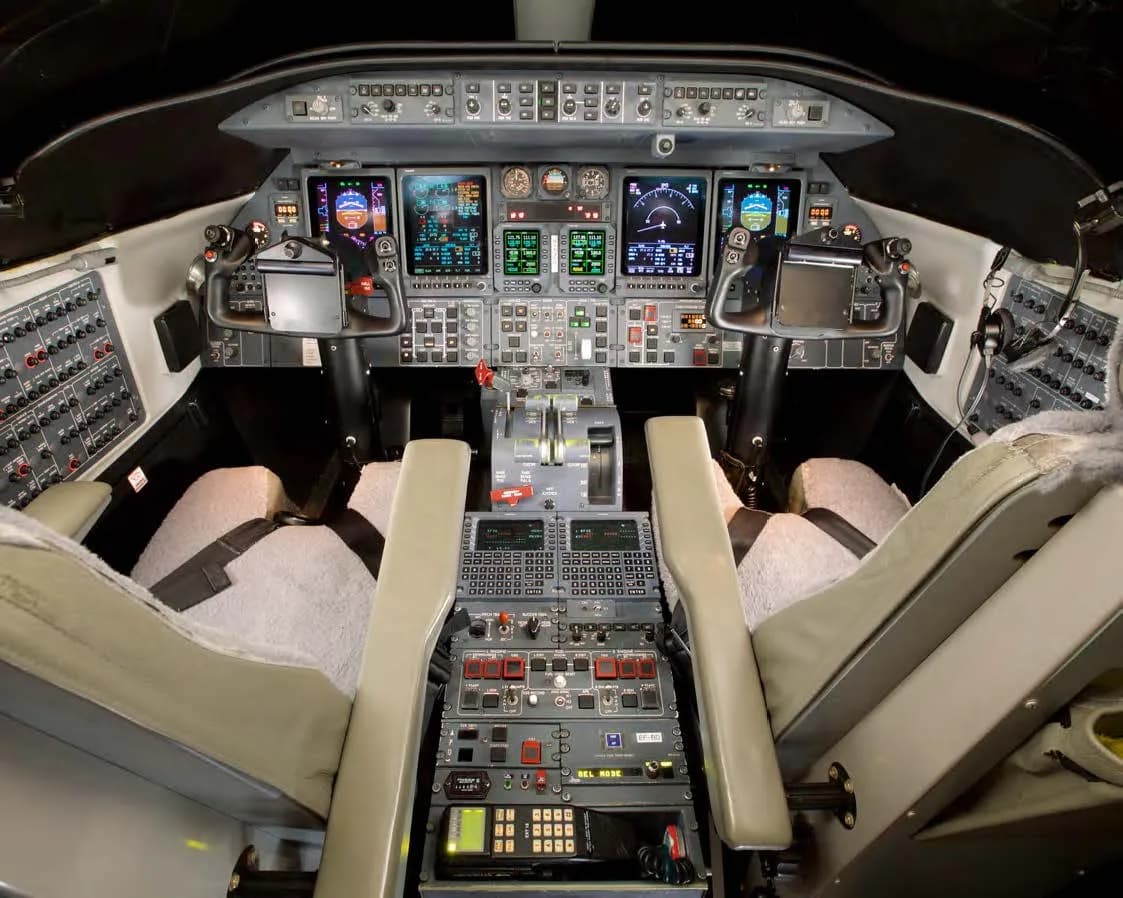 View of the aircraft cockpit with instrument panel and seats.