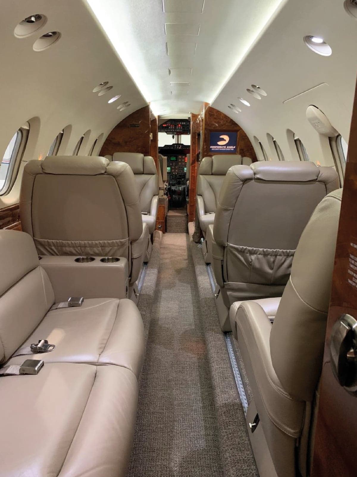 View down the aisle of the aircraft cabin with leather seats.