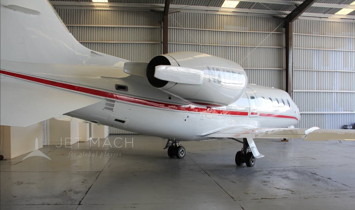 Rear view of the N317EC aircraft in a hangar, showing the engine and tail section.
