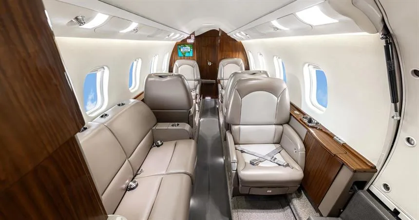 Aircraft cabin with seats and divan.