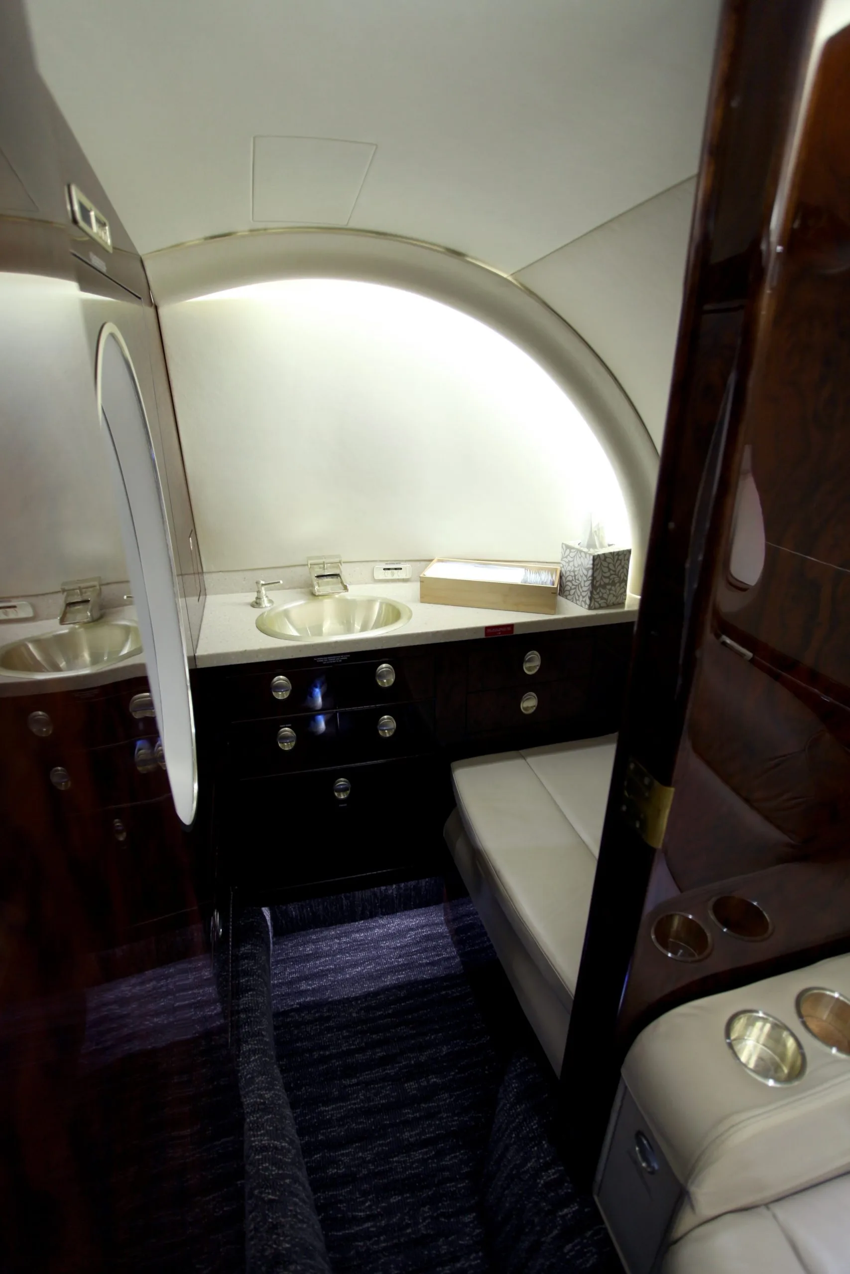The lavatory in a Hawker 400XP aircraft with a sink and vanity.